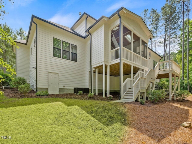 67 Spring Hollow Ct, Pittsboro, NC 27312 - back of property featuring stairs, a sunroom, a yard, and a wooden deck