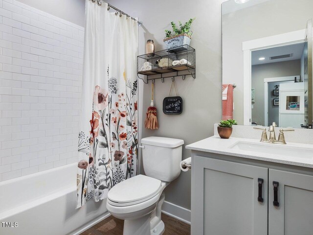 67 Spring Hollow Ct, Pittsboro, NC 27312 - full bath featuring toilet, vanity, wood finished floors, shower / tub combo, and baseboards
