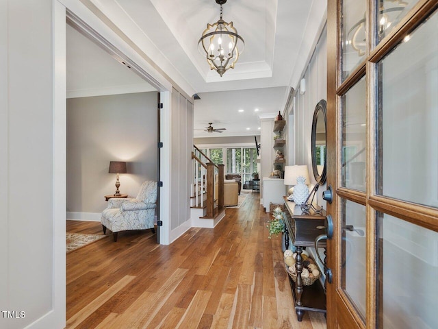 67 Spring Hollow Ct, Pittsboro, NC 27312 - foyer entrance with a chandelier, light wood finished floors, stairs, crown molding, and baseboards