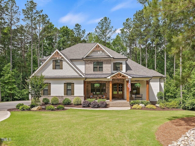 67 Spring Hollow Ct, Pittsboro, NC 27312 - craftsman-style house with covered porch, a front yard, roof with shingles, and a standing seam roof
