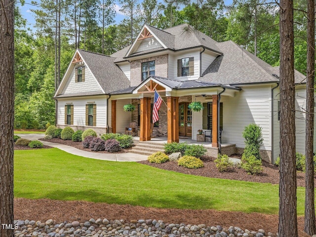 67 Spring Hollow Ct, Pittsboro, NC 27312 - craftsman-style home featuring a shingled roof, a porch, a front lawn, and brick siding