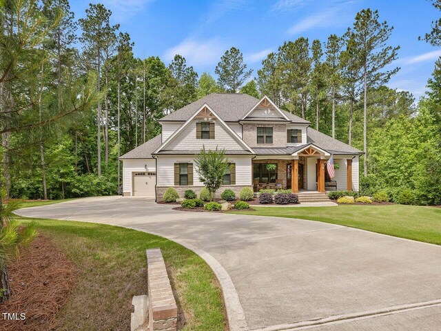 67 Spring Hollow Ct, Pittsboro, NC 27312 - view of front of property featuring an attached garage, covered porch, concrete driveway, a front yard, and roof with shingles