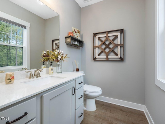 67 Spring Hollow Ct, Pittsboro, NC 27312 - half bathroom with wood finished floors, vanity, toilet, and baseboards