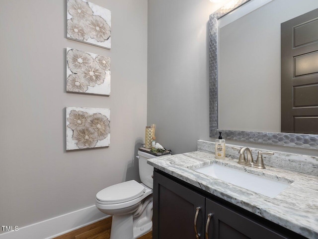 67 Spring Hollow Ct, Pittsboro, NC 27312 - half bath featuring vanity, toilet, and wood finished floors