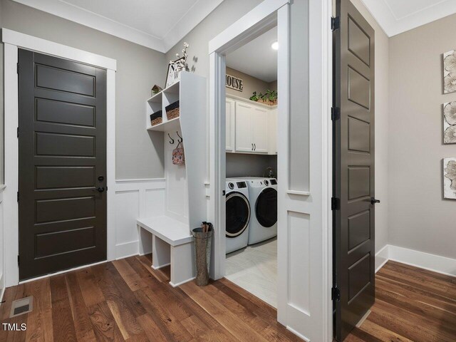 67 Spring Hollow Ct, Pittsboro, NC 27312 - laundry area featuring washer and clothes dryer, cabinet space, dark wood-style floors, wainscoting, and crown molding