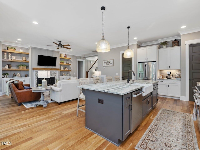 67 Spring Hollow Ct, Pittsboro, NC 27312 - kitchen featuring appliances with stainless steel finishes, ornamental molding, a sink, a ceiling fan, and white cabinetry