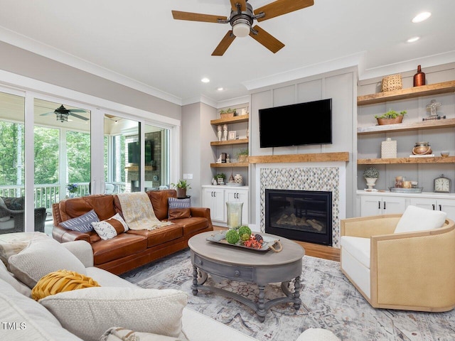 67 Spring Hollow Ct, Pittsboro, NC 27312 - living room with a ceiling fan, ornamental molding, light wood finished floors, a tile fireplace, and recessed lighting