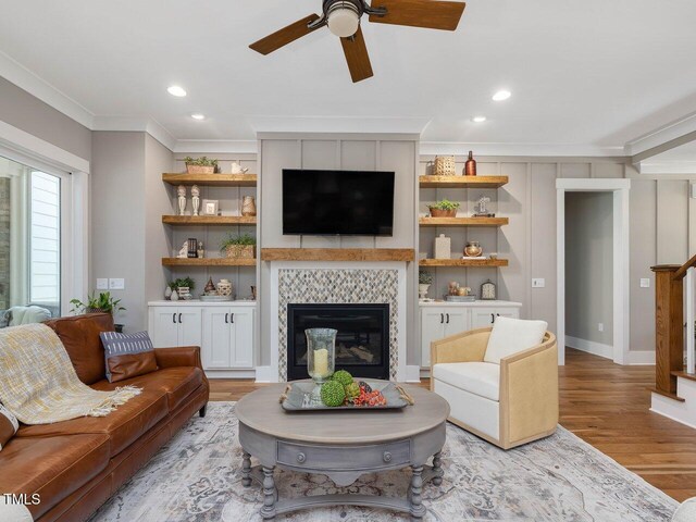 67 Spring Hollow Ct, Pittsboro, NC 27312 - living area featuring ornamental molding, light wood-style floors, a ceiling fan, a tiled fireplace, and recessed lighting