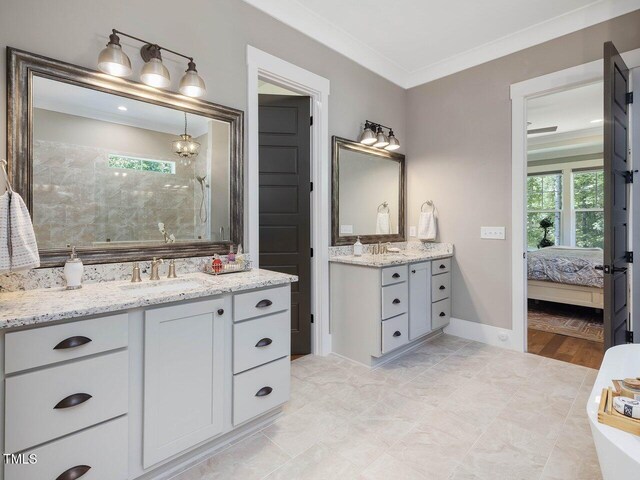67 Spring Hollow Ct, Pittsboro, NC 27312 - ensuite bathroom featuring two vanities, tiled shower, baseboards, and crown molding