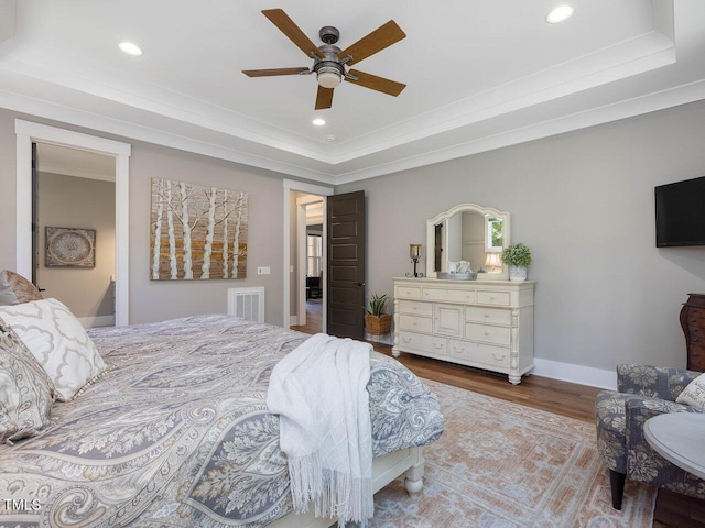 67 Spring Hollow Ct, Pittsboro, NC 27312 - bedroom featuring a tray ceiling, wood finished floors, ornamental molding, recessed lighting, and baseboards
