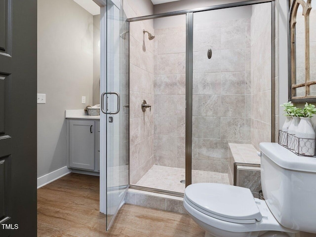 67 Spring Hollow Ct, Pittsboro, NC 27312 - bathroom featuring toilet, a stall shower, wood finished floors, baseboards, and vanity