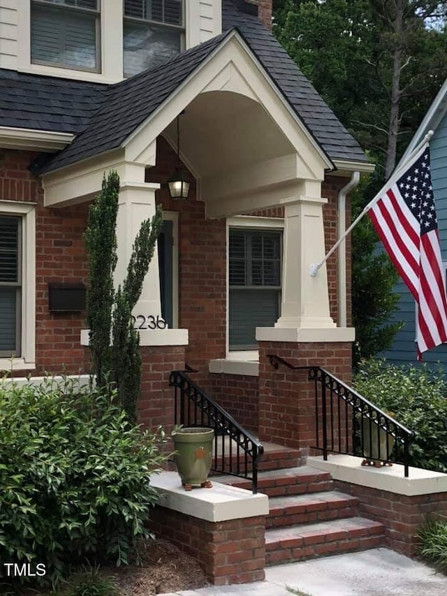 2236 The Cir, Raleigh, NC 27608 - view of exterior entry featuring brick siding and a chimney