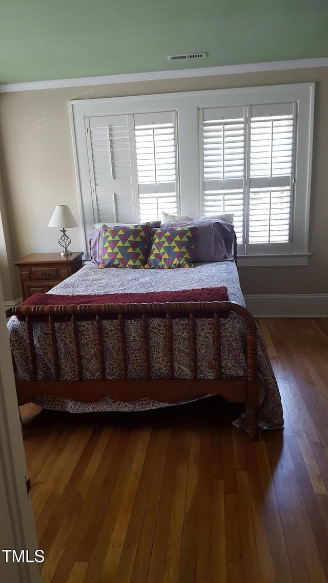 2236 The Cir, Raleigh, NC 27608 - bedroom featuring dark wood finished floors, multiple windows, and baseboards