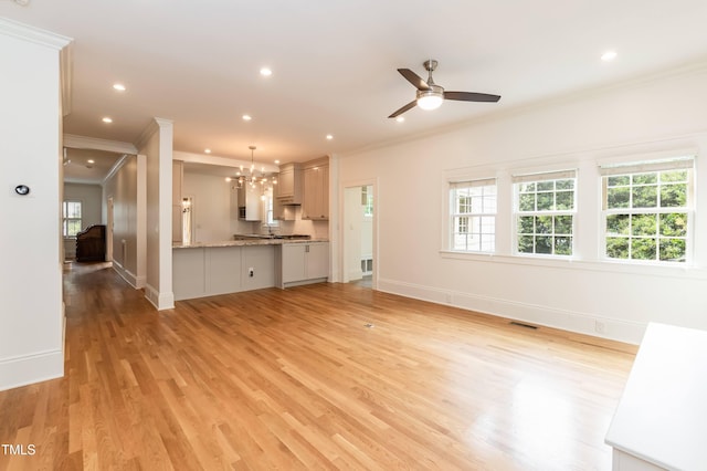 2236 The Cir, Raleigh, NC 27608 - unfurnished living room with ornamental molding, healthy amount of natural light, baseboards, a ceiling fan, and light wood-type flooring