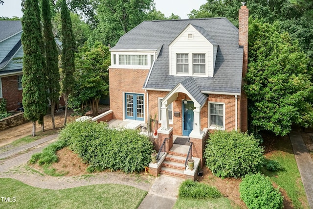 2236 The Cir, Raleigh, NC 27608 - view of front facade featuring a chimney, brick siding, and a shingled roof