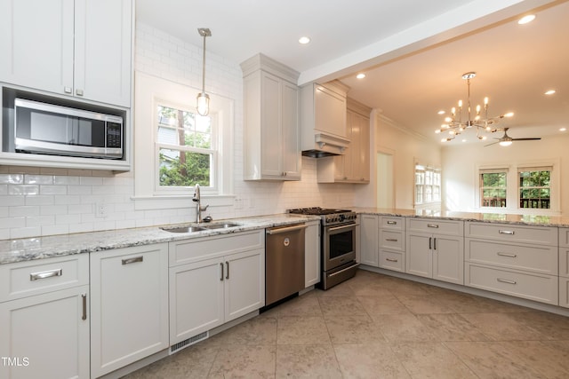 2236 The Cir, Raleigh, NC 27608 - kitchen featuring a sink, stainless steel appliances, tasteful backsplash, a chandelier, and decorative light fixtures