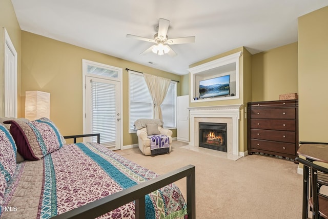 9808 Rainsong Dr, Wake Forest, NC 27587 - carpeted bedroom featuring a fireplace, a ceiling fan, baseboards, and access to exterior