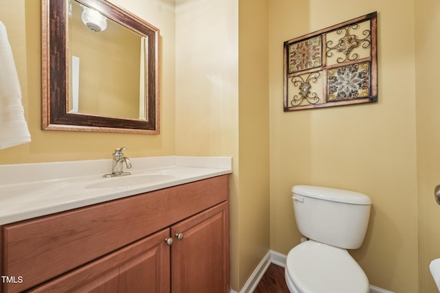 9808 Rainsong Dr, Wake Forest, NC 27587 - bathroom with toilet, vanity, baseboards, and wood finished floors