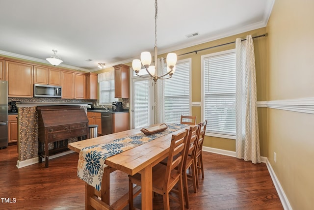 9808 Rainsong Dr, Wake Forest, NC 27587 - dining area featuring a chandelier, baseboards, dark wood-type flooring, and ornamental molding