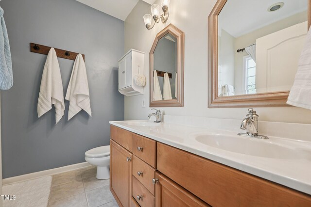 9808 Rainsong Dr, Wake Forest, NC 27587 - bathroom featuring double vanity, toilet, tile patterned floors, and baseboards