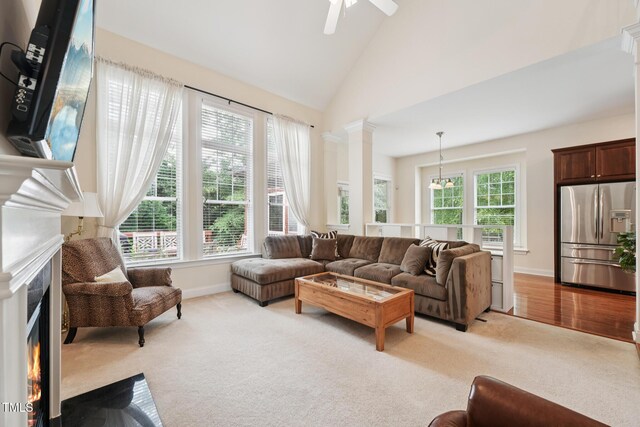 7 Teahouse Ct, Durham, NC 27707 - living room featuring a fireplace with flush hearth, light carpet, baseboards, ceiling fan, and high vaulted ceiling