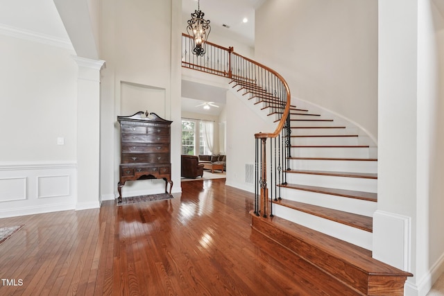7 Teahouse Ct, Durham, NC 27707 - entryway with wood-type flooring, stairway, a chandelier, a high ceiling, and baseboards