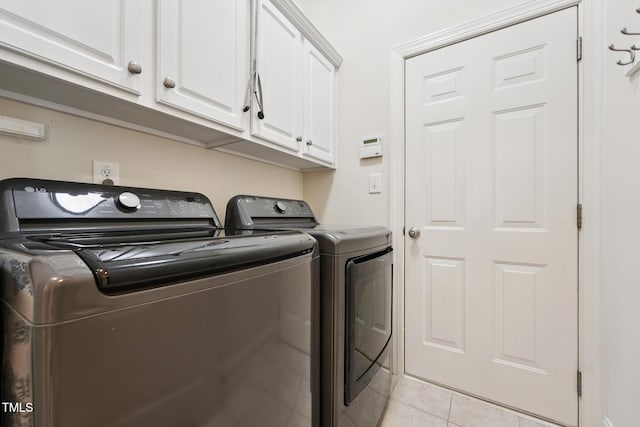 7 Teahouse Ct, Durham, NC 27707 - laundry area featuring independent washer and dryer, cabinet space, and light tile patterned floors