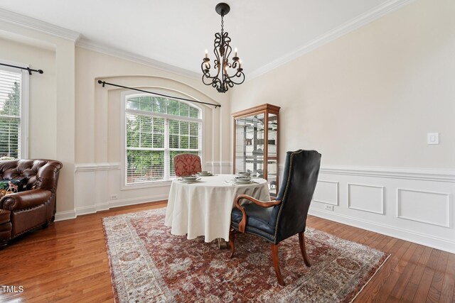 7 Teahouse Ct, Durham, NC 27707 - dining room featuring a chandelier, light wood finished floors, plenty of natural light, crown molding, and wainscoting