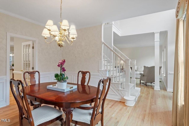 103 Rose Sky Ct, Cary, NC 27513 - dining area featuring light wood-style flooring, a chandelier, wainscoting, stairs, and crown molding