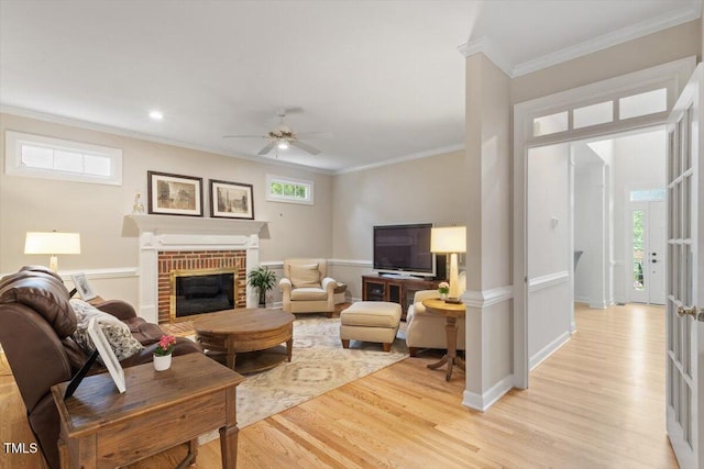 103 Rose Sky Ct, Cary, NC 27513 - living room with crown molding, light wood finished floors, ceiling fan, a fireplace, and recessed lighting