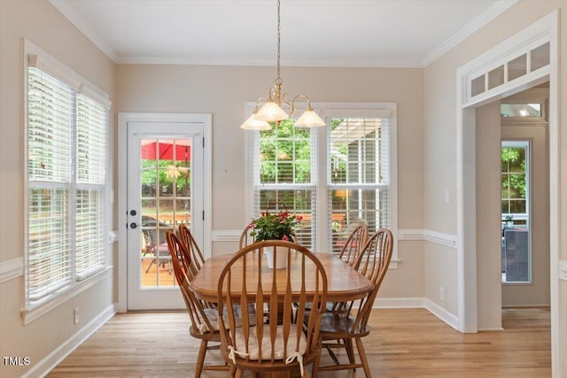 103 Rose Sky Ct, Cary, NC 27513 - dining area with light wood-type flooring, healthy amount of natural light, crown molding, a chandelier, and baseboards