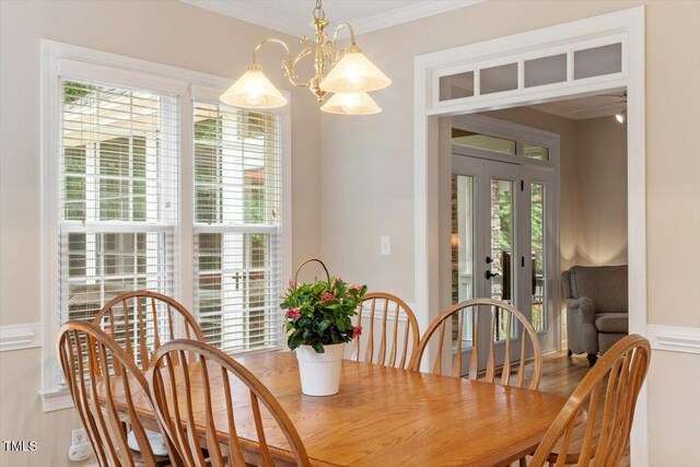 103 Rose Sky Ct, Cary, NC 27513 - dining area featuring french doors, crown molding, and a chandelier
