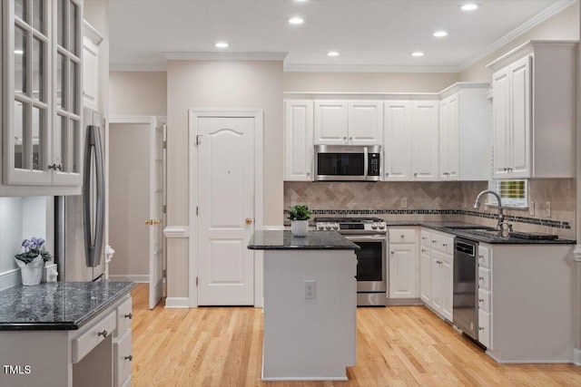 103 Rose Sky Ct, Cary, NC 27513 - kitchen featuring stainless steel appliances, a sink, white cabinets, a kitchen island, and ornamental molding
