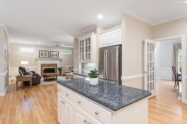 103 Rose Sky Ct, Cary, NC 27513 - kitchen with freestanding refrigerator, ceiling fan, light wood-type flooring, white cabinets, and a kitchen island