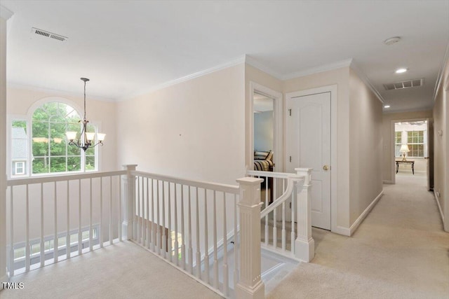 103 Rose Sky Ct, Cary, NC 27513 - hallway with carpet flooring, an upstairs landing, a chandelier, crown molding, and plenty of natural light