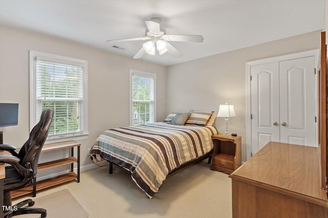 103 Rose Sky Ct, Cary, NC 27513 - bedroom with light colored carpet, ceiling fan, a closet, a desk, and baseboards