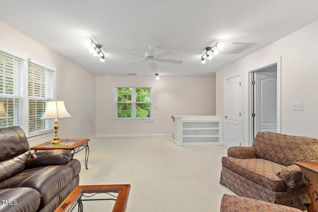 103 Rose Sky Ct, Cary, NC 27513 - living area featuring track lighting, light colored carpet, ceiling fan, and baseboards
