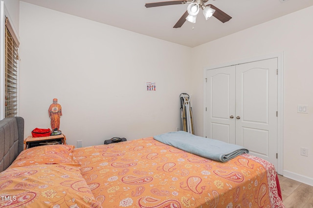 425 Liberty Hl, Morrisville, NC 27560 - bedroom with light wood finished floors, a closet, baseboards, and a ceiling fan