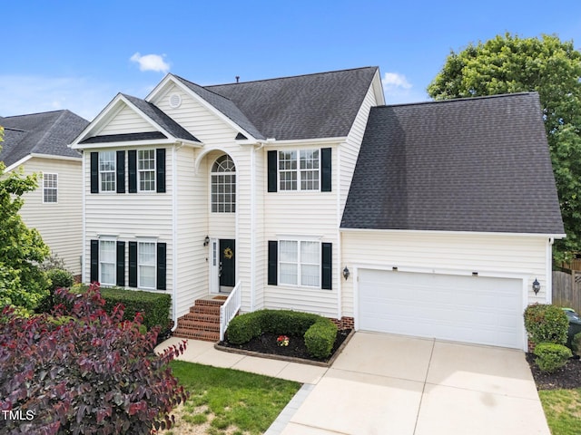5942 Big Nance Dr, Raleigh, NC 27616 - traditional home with driveway, an attached garage, and a shingled roof