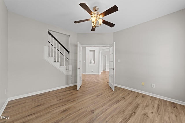 5942 Big Nance Dr, Raleigh, NC 27616 - empty room with light wood-style floors, french doors, baseboards, stairs, and ceiling fan