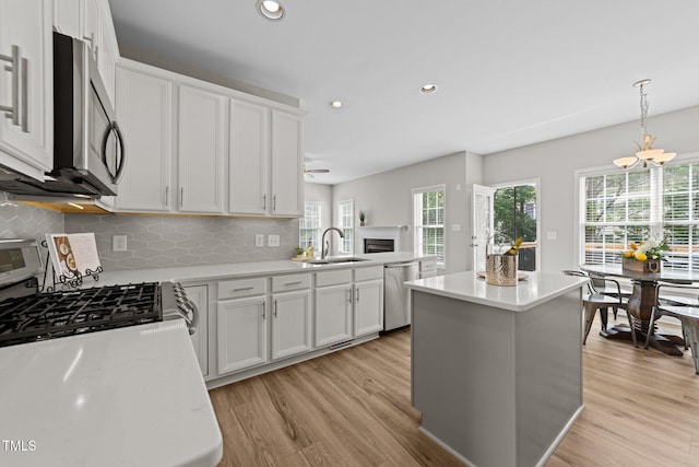 5942 Big Nance Dr, Raleigh, NC 27616 - kitchen featuring appliances with stainless steel finishes, light wood-type flooring, light countertops, recessed lighting, and decorative backsplash