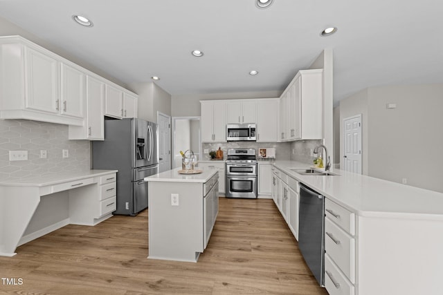 5942 Big Nance Dr, Raleigh, NC 27616 - kitchen featuring stainless steel appliances, a sink, a peninsula, decorative backsplash, and recessed lighting