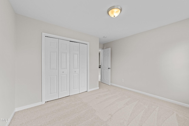 5942 Big Nance Dr, Raleigh, NC 27616 - unfurnished bedroom with carpet flooring, baseboards, and a closet