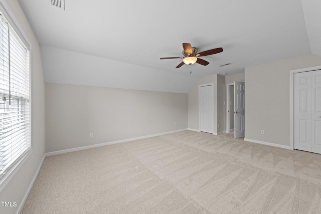 5942 Big Nance Dr, Raleigh, NC 27616 - unfurnished bedroom featuring two closets, light colored carpet, vaulted ceiling, baseboards, and ceiling fan