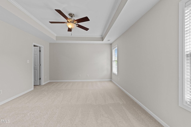 5942 Big Nance Dr, Raleigh, NC 27616 - carpeted empty room featuring a tray ceiling, ceiling fan, crown molding, and baseboards