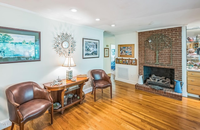 582 Wimbleton Dr, Raleigh, NC 27609 - living area featuring ornamental molding, wood finished floors, a fireplace, recessed lighting, and baseboards