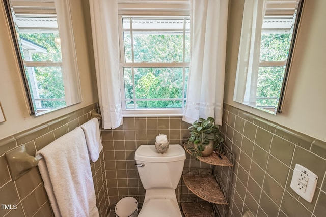 582 Wimbleton Dr, Raleigh, NC 27609 - bathroom featuring tile walls, healthy amount of natural light, toilet, and wainscoting
