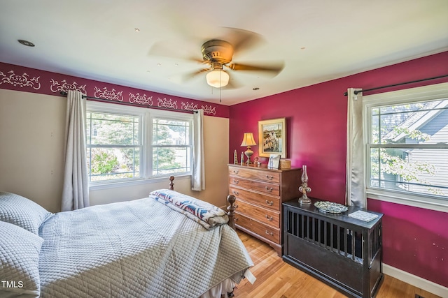 582 Wimbleton Dr, Raleigh, NC 27609 - bedroom featuring multiple windows, light wood-style floors, and a ceiling fan