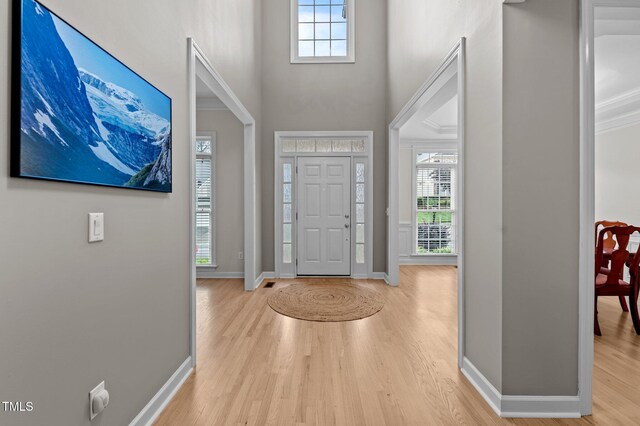 13121 Sargas St, Raleigh, NC 27614 - entryway with a towering ceiling, baseboards, and wood finished floors