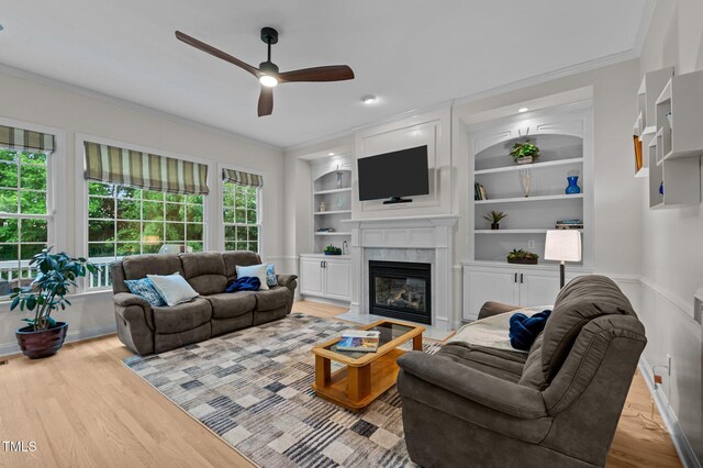 13121 Sargas St, Raleigh, NC 27614 - living area with a ceiling fan, crown molding, a premium fireplace, wood finished floors, and built in shelves